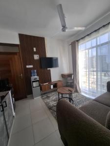 a living room with a couch and a table at Bahari Home in Nyali