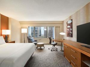 a hotel room with a bed and a desk at Swissotel Chicago in Chicago
