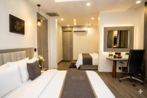 a hotel room with a bed and a desk at ZED Plaza in New Delhi