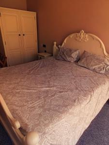 a bedroom with a large bed with a white comforter at Chartridge Lodge Hotel in Chesham +9 photos
