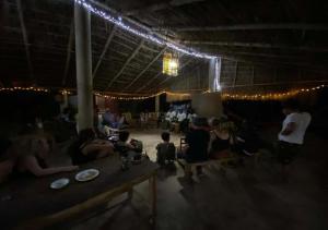 a group of people sitting in a room with lights at Appart'Haris in Ouidah