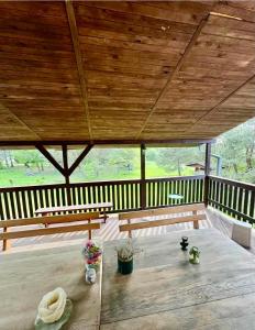 a porch with two benches and a wooden ceiling at NOCLEGI NOVA in Krasnobród