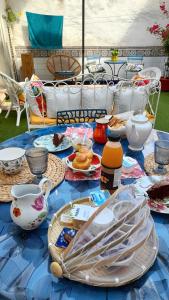 a blue table with plates of food on it at les hirondelles de Barrou in Saint-Jean-de-Barrou
