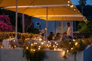 a group of people sitting at a table under an umbrella at Boutique Hotel and Spa Blanc & Bleu - Blanche in Herceg-Novi +112 photos
