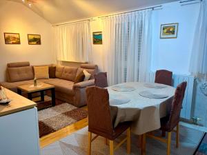 a living room with a table and a couch at Sunshine Apartments Podstrana in Podstrana