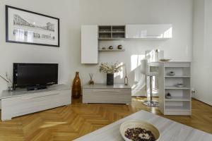 a white living room with a flat screen tv at TONIOLO VENICE ROOMS in Mestre