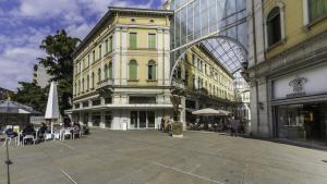 a large building with people sitting outside of it at TONIOLO VENICE ROOMS in Mestre
