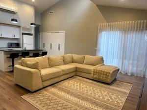 a living room with a couch and a kitchen at Central 3BR Home in Mansfield
