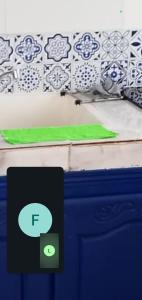 a green rug sitting on top of a bed at Marina in Tipaza