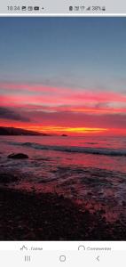 a view of a sunset over the ocean at Marina in Tipaza