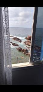 a view of the ocean from a window at Marina in Tipaza