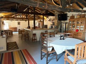 a room with a table and chairs and a bar at Chez Paulet A welcome break for peace and tranquility - route C27 in Lobard