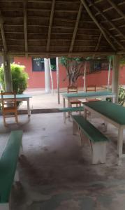 a group of picnic tables in a pavilion at Appart'Haris in Ouidah