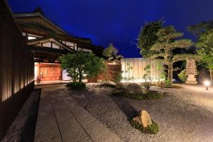 a building with a tree in front of it at Fuji Onsenji Yumedono in Fujikawaguchiko