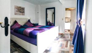 a bedroom with a large bed with colorful pillows at Feriendomizil Bockelmann in Bad Bevensen