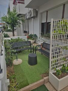 a garden with two benches and a fence at Alle Nuove Stelle in Udine