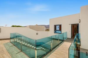 a glass staircase in a white building at Callao Beach 9 in Arrieta