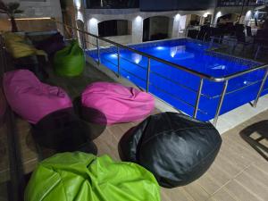 a swimming pool with three bean bags next to it at Apartments Mekic in Utjeha