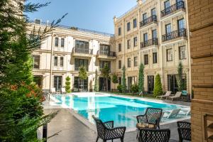 a courtyard with a swimming pool in front of a building at Meridian Plaza by Reikartz in Samarkand