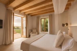 a bedroom with a large bed and a large window at Fontsanta Hotel Thermal & Spa - Adults Only in Colònia de Sant Jordi +102 photos