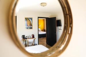 a mirror reflection of a room with a bedroom at Boutique Hotel Enkhuizen in Enkhuizen
