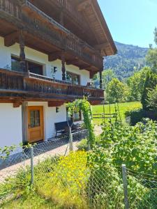 a house with a balcony on the side of it at Landhaus Gollner in Uderns