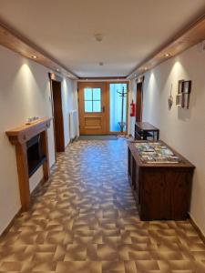 a hallway with a table in the middle of a room at Landhaus Gollner in Uderns