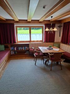 a living room with a table and a couch at Landhaus Gollner in Uderns