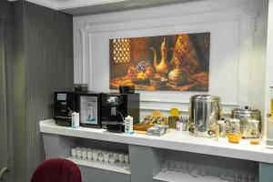 a counter in a hotel room with a table with food at Meridian Plaza by Reikartz in Samarkand
