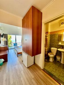 a bathroom with a toilet and a sink at Hotel Akti in Loutraki