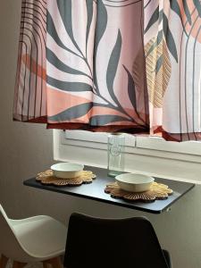 a table with two bowls and a window at Nonna Consolata Studio - 25 min to Cagliari & Beaches in Dolianova +18 photos