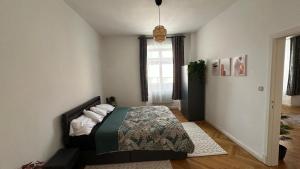 a bedroom with a bed and a window at Holstentor Apartment in Lübeck +5 photos