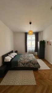 a bedroom with a bed and a window at Holstentor Apartment in Lübeck