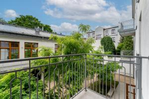 an apartment balcony with trees and buildings at Friendhouse Residence in Krakow