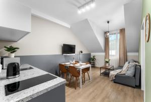 a kitchen and living room with a table and a couch at Friendhouse Residence in Krakow