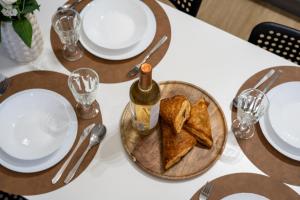 a table with a plate of food and a bottle of wine at Friendhouse Residence in Krakow +165 photos