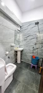a bathroom with a sink and a toilet and a tub at Hotel Anjana Cottage - Stay 5 min Away From Golden Temple in Amritsar