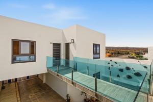 a view from the balcony of a house with a swimming pool at Callao Beach 10 in Arrieta