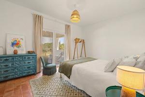 a bedroom with a bed and a table and a chair at Monte Do Poço Country House in Erra +37 photos