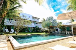 an image of a swimming pool in front of a house at Le Mandala Moris Boutique Hotel in Grand-Baie