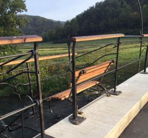 a wooden bench sitting on top of a bridge at Ferienhaus Trautner in Muggendorf