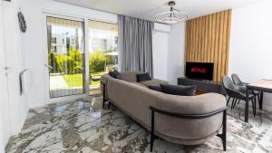 a living room with a couch and a table at Garden View Apartment in Rrushkull
