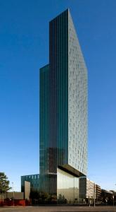 a tall glass building with a lot of windows at Meliá Barcelona Sky 4 Sup in Barcelona