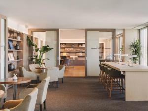 a restaurant with chairs and tables and a dining room at Meliá Barcelona Sky 4 Sup in Barcelona +87 photos