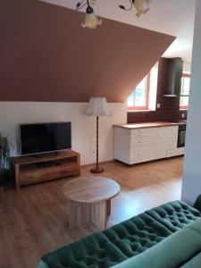 a living room with a couch and a table at Penzion Farma Dolík in Havlíčkŭv Brod