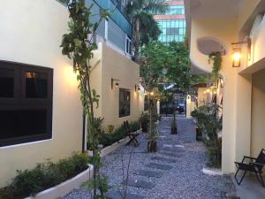 a courtyard with potted plants and stairs in a building at BalaHomestay BalaHouse in Lạc Thành