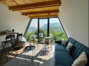 a living room with a blue couch and chairs at Engadin Mountain Kucica in Brda