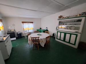 a kitchen with a table and chairs in a room at Verbe Farm Accommodation in Kamieskroon +21 photos