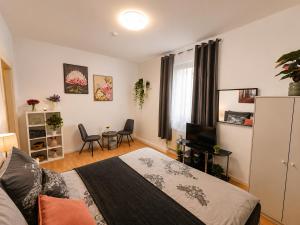 a bedroom with a bed and a table and chairs at Bright and Elegant Private Room in Dresden