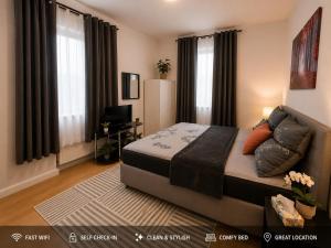 a bedroom with a bed in a room with windows at Bright and Elegant Private Room in Dresden